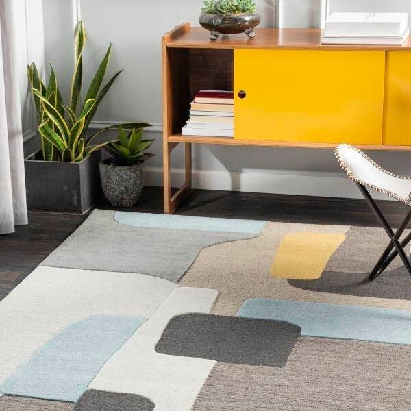 Geometric rug with gray, blue, and yellow shapes