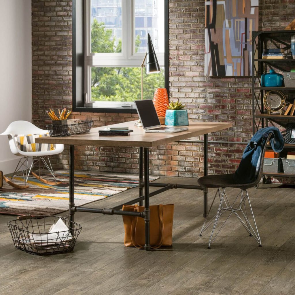 Home office with rustic brown vinyl flooring and industrial desk
