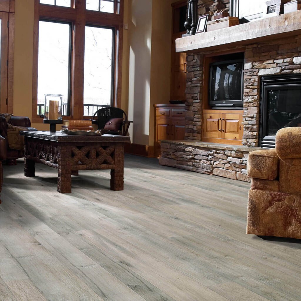 Gray laminate flooring in rustic living room with fireplace